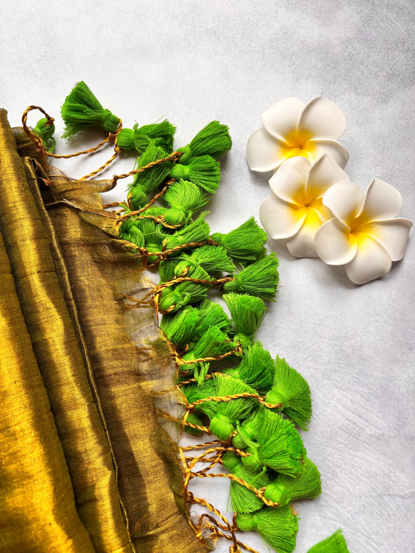 Raga Tissue Kadhi Cotton Saree with Green Tassels & Golden Mirror Work | The Laya Looms