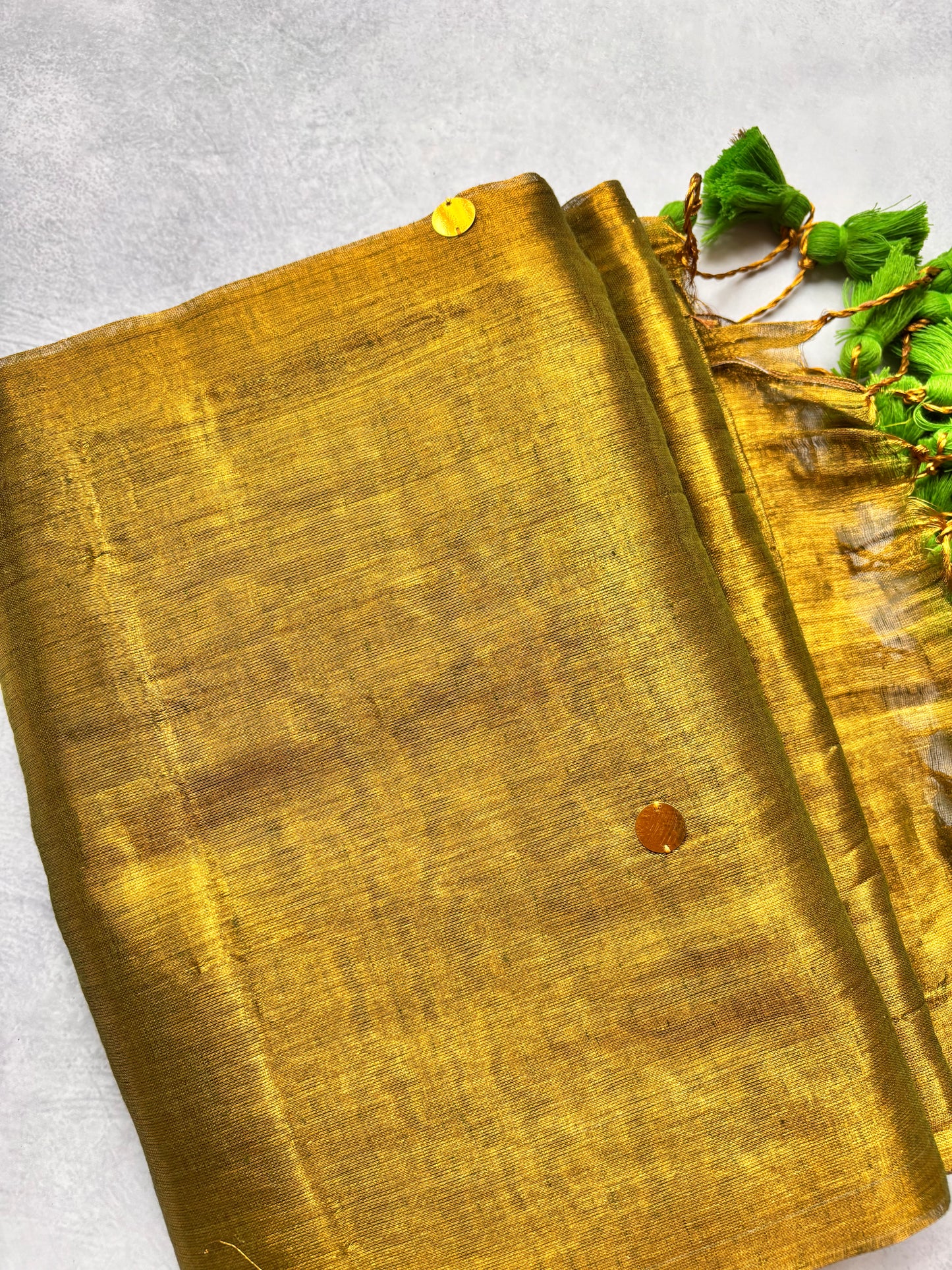 Raga Tissue Kadhi Cotton Saree with Green Tassels & Golden Mirror Work | The Laya Looms