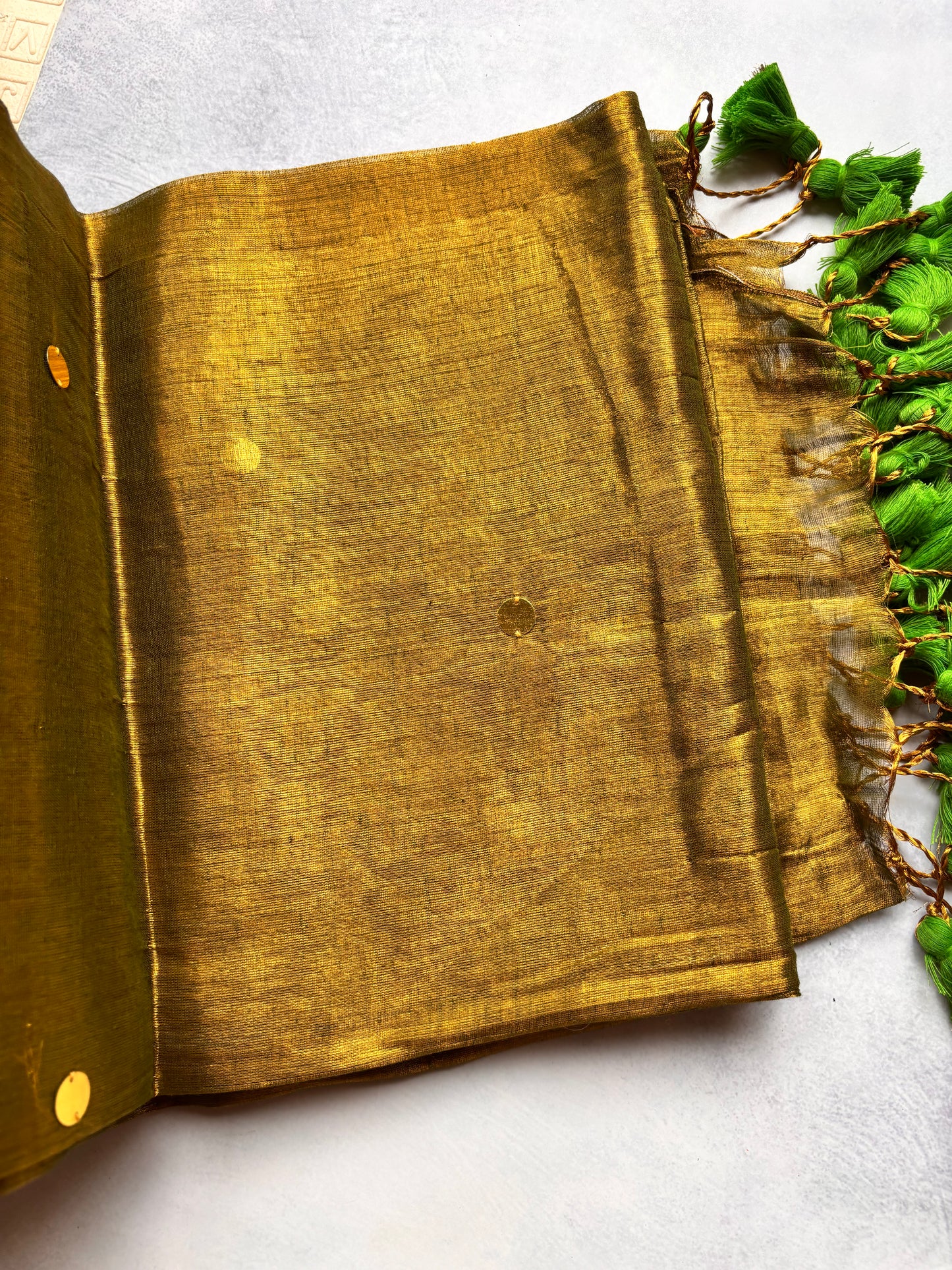 Raga Tissue Kadhi Cotton Saree with Green Tassels & Golden Mirror Work | The Laya Looms
