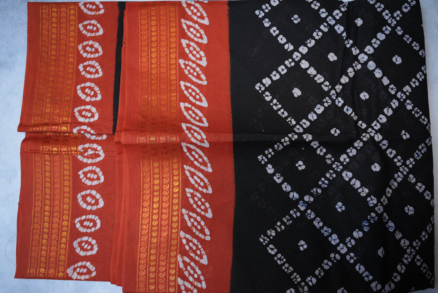 Batik Cross Print Black Saree with Orange Border