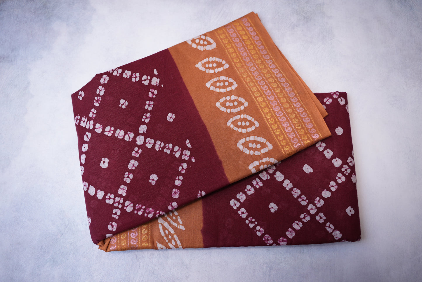 Batik Cross Print Maroon Saree with Orange Border