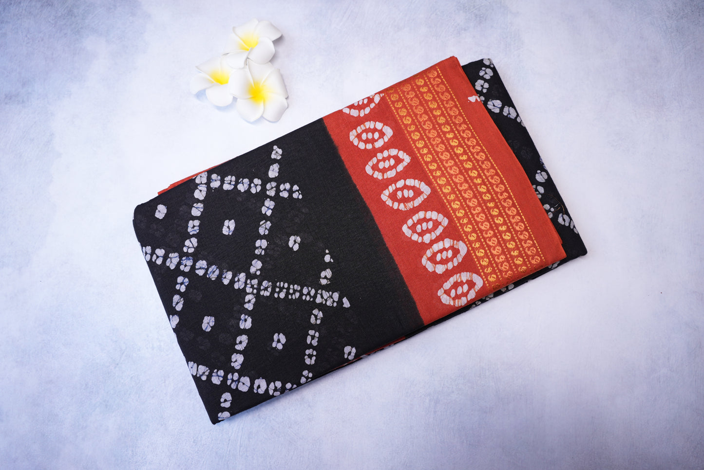 Batik Cross Print Black Saree with Orange Border