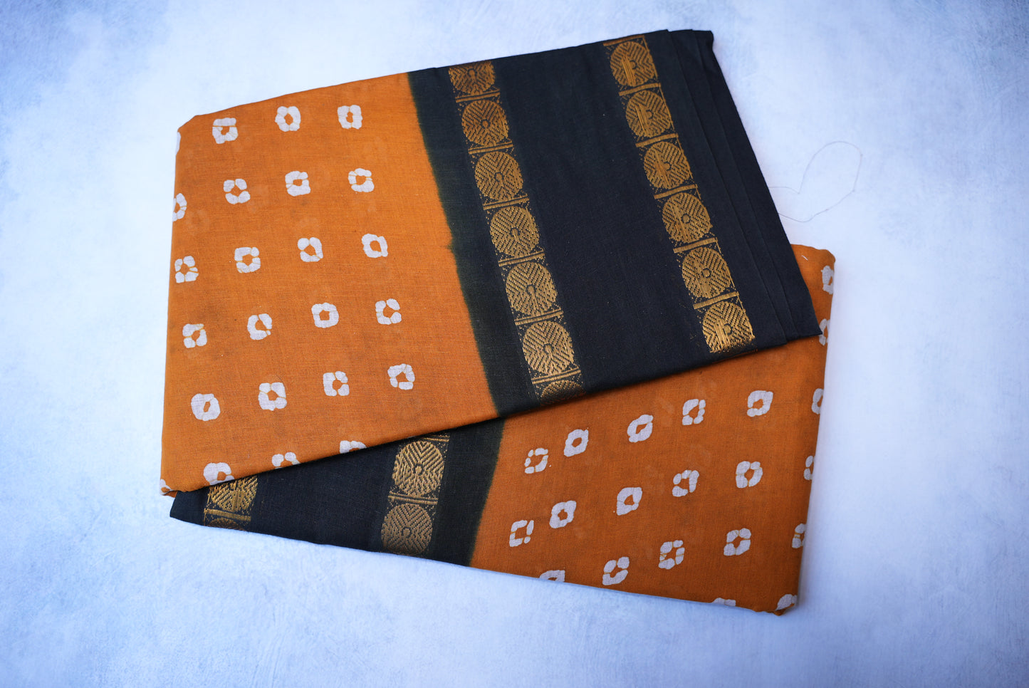 Traditional Batik Print Light Orange Saree with Black Border