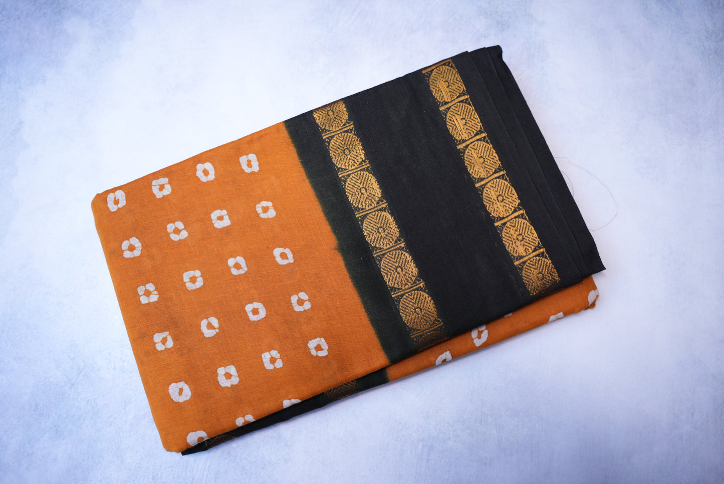 Traditional Batik Print Light Orange Saree with Black Border