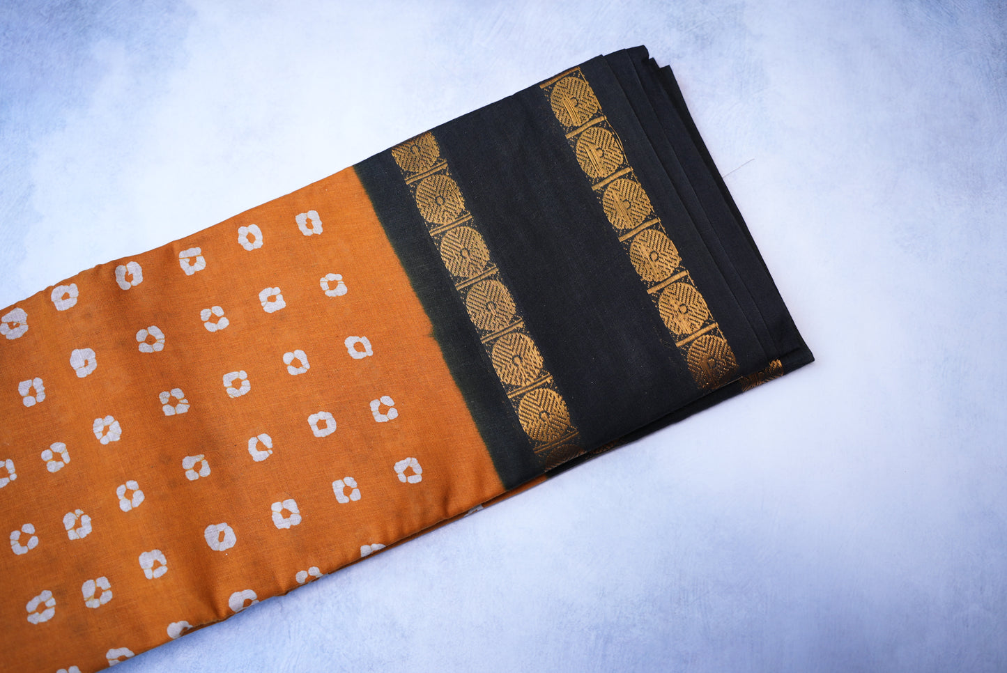 Traditional Batik Print Light Orange Saree with Black Border