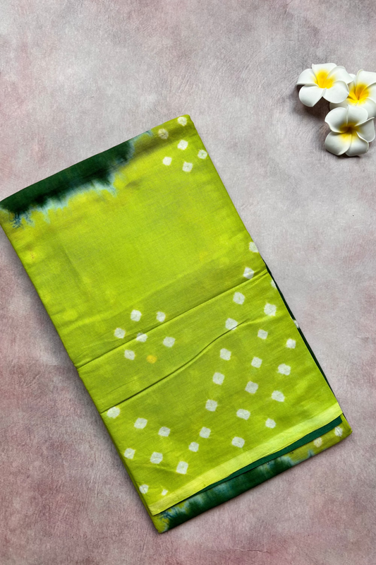 Green sungudi with white patterns on a gray surface with flowers.